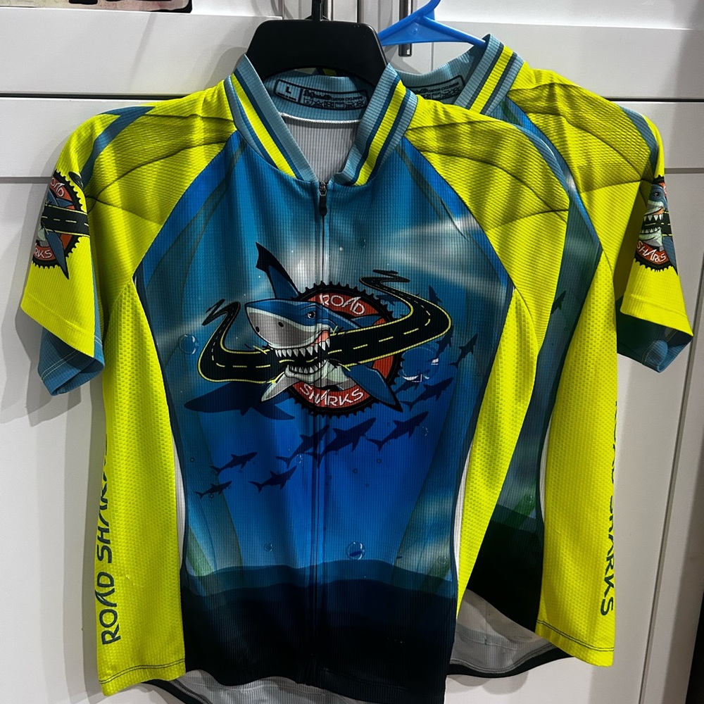THREE cycling tops.  Two L Cycling Jerseys 1 M Cycling Vest